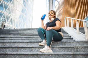 Woman smiles as she takes a break from her weight loss workout